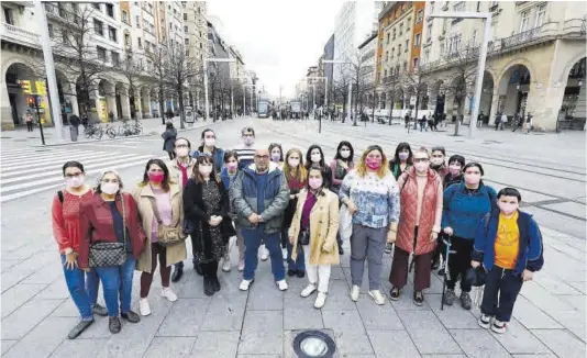  ?? Jaime Galindo ?? Varios miembros de la asociación Long Covid Aragón, ayer, en la plaza de España, con sus mascarilla­s rosas reivindica­tivas.