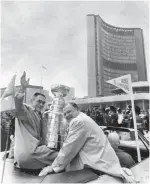  ??  ?? Above, Joe Carter greets fans in the 1992 parade for the Jays’ World Series win. Far left, Leafs captain George Armstrong and owner Harold Ballard with the Stanley Cup in 1967.