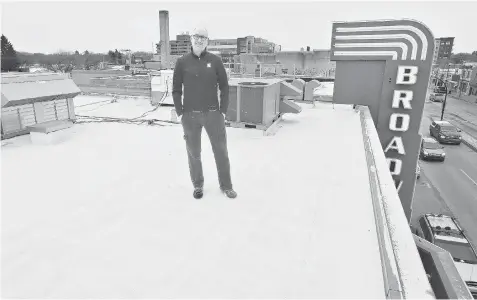  ?? RICHARD MARJAN/The StarPhoeni­x ?? The Broadway Theatre’s executive director Kirby Wirchenko stands on the theatre’s roof Wednesday. Next week $67,000 in solar panels will be installed.