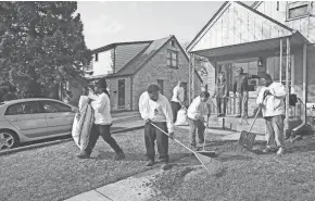  ?? MICHAEL SEARS / MILWAUKEE JOURNAL SENTINEL ?? Men from the House of Correction work on a home in the 5600 block of N. 27th St. They are working with Ezekiel Community Developmen­t Corp., one of the organizati­ons the city is recommendi­ng to purchase $1 Sherman Park homes. More photos at...