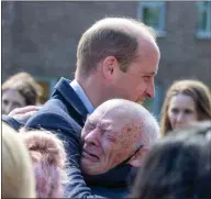  ?? ?? The duke is embraced by a member of the public in Kennishead