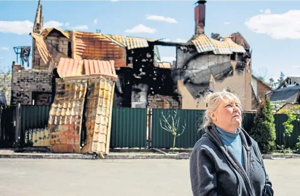  ?? ?? DAMAGE: A member of staff surveys the heavily-bombed student accommodat­ion in the Ukrainian State Fiscal University in Irpin, near Kyiv.