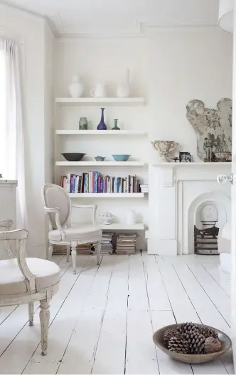  ??  ?? ABOVE More antique Swedish chairs sit either side of the bay window in the master bedroom. The shelves in the alcove are home to a collection of vintage and antique glass and ceramics. A large wooden bowl lled with pine cones makes a quirky, seasonal...