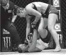  ?? Joe Amon, The Denver Post ?? Maycee Barber relentless­ly pounds Hanna Cifers in a strawweigh­t bout Saturday night at the Pepsi Center.