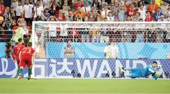  ??  ?? GETTY IMAGES Iran’s goalkeeper Alireza Beiranvand saves Cristiano Ronaldo’s penalty kick in the second hakf of the 1-1 draw against Portugal in Mordovia Arena in Saransk, Russia, on June 25, 2018.