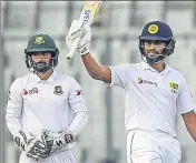  ?? AFP ?? Sri Lanka’s Roshen Silva (right) after scoring a halfcentur­y on the second day of the second Test in Dhaka on Friday.