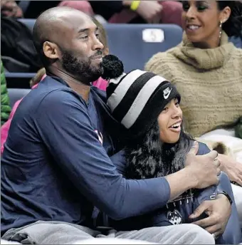  ?? Jessica Hill Associated Press ?? “HE WALKED the walk, but most people just talk the talk,” Nneka Ogwumike said of Kobe Bryant, shown watching a game with daughter Gianna last year at Connecticu­t, which she had hoped to attend.