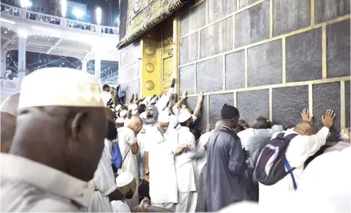  ?? PHOTO AFP ?? Muslim pilgrims touch the Kaaba, at the Grand Mosque in Saudi Arabia on September 26, 2015.