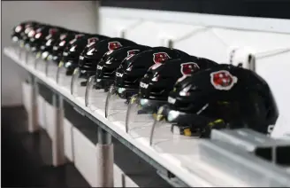  ?? NEWS FILE PHOTO RYAN MCCRACKEN ?? Helmets sit on the Medicine Hat Tigers’ bench prior to their 2019-20 home opener against the Lethbridge Hurricanes at what is now Co-Op Place. The Tigers open their 24-game Western Hockey League season tonight in Red Deer against the Rebels at 6 p.m.