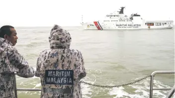  ?? — Photo by Chimon Upon ?? MMEA personnel watch as the OPV1 goes on its maiden patrol.