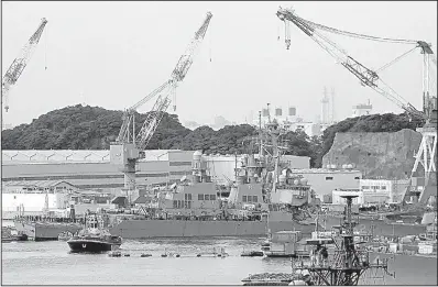  ?? AP/EUGENE HOSHIKO ?? The USS Fitzgerald arrives for repairs Saturday at Yokosuka Naval Base, Japan, as officials worked to determine the cause of the destroyer’s collision with the ACX Crystal cargo ship in a busy sea lane.