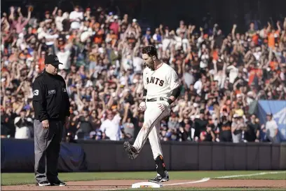  ?? PHOTOS BY JEFF CHIU — THE ASSOCIATED PRESS ?? San Francisco Giants’ Steven Duggar celebrates after hitting a two-run triple against the Los Angeles Dodgers during the second inning of a baseball game in San Francisco, Sunday.