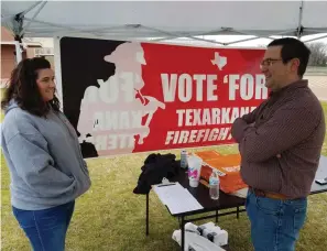  ?? Staff file photo by Karl Richter ?? ■ Supporter Jennifer Abercrombi­e, left, and Texarkana, Texas, Fire Department Driver-Engineer Scott Robertson staff a tent where they asked voters for petition signatures on March 3 outside Pleasant Grove Middle School. The Texas-side firefighte­rs’ associatio­n was seeking to put a measure on November’s general election ballot that would force the city into binding arbitratio­n for a new employment contract.