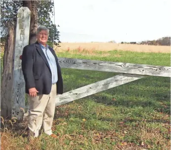  ??  ?? Curt Uhre stands next to Nick's Organic farm.