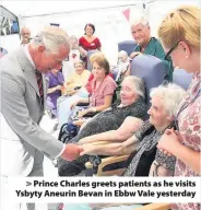  ??  ?? > Prince Charles greets patients as he visits Ysbyty Aneurin Bevan in Ebbw Vale yesterday