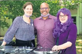  ?? COURTESY OF WHITE HORSE VILLAGE ?? Christine Cooney, left, DJ Malcolm Poindexter III and Susan Abtouche, White Horse Village vice president of mission enhancemen­t, spin festive tunes to motivate walkers and entertain attendees at the event.