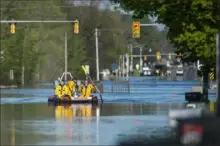  ?? Katy Kildee/Midland Daily News via AP ?? A search and rescue boat deploys Wednesday as floodwater rises in Midland, Mich.