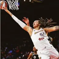  ?? Chase Stevens / Associated Press ?? Phoenix Mercury center Brittney Griner shoots next to Las Vegas Aces center Liz Cambage, obscured, during the first half of Game 5 of a WNBA playoff series in October.