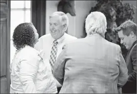  ?? AP/St. Louis Post-Dispatch/DAVID CARSON ?? Missouri Lt. Gov. Mike Parson (second from left) greets Sen. Shalonn “Kiki” Curls (left), Senate Minority Leader Gina Walsh and former senator and Public Service Commission member Ryan Silvey (right) in his office Wednesday in Jefferson City, Mo. Parson will automatica­lly ascend from lieutenant governor to governor on Friday when Gov. Eric Greitens steps down following investigat­ions of his political and personal life.