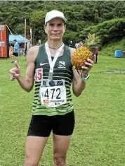  ?? Picture: SUPPLIED ?? LONG RUN: Makhanda’s Terri-Lynn Penney celebrates with her medal and pineapple at the PA Country Club after finishing first in the women's veteran 27km category at Saturday's Pineapple Run. She was placed third overall in the women’s section.