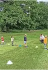  ??  ?? Dave at work with some young golfers