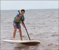  ?? SUBMITTED ?? Jessi MacKinnon enjoys trying his hand at stand up paddle boarding with The Summer Program offered through The Adventure Group.