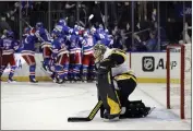  ?? ADAM HUNGER — THE ASSOCIATED PRESS ?? The Rangers celebrate a game-winning goal in OT by Artemi Panarin on Penguins goalie Tristan Jarry in Game 7.