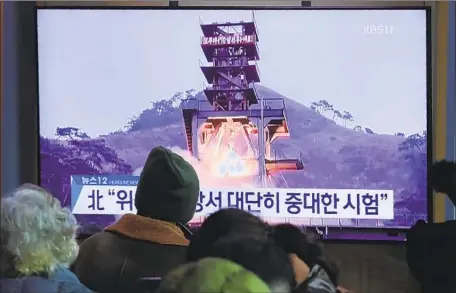  ?? AHN YOUNG-JOON Associated Press ?? PEOPLE at the Seoul Railway Station watch a broadcast Monday about a “very important test” at North Korea’s long-range rocket site.