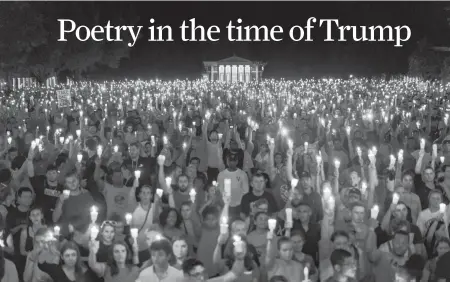  ?? Jason Lappa / New York Times ?? A student read Maya Angelou’s “Still I Rise” for the thousands gathered at a candleligh­t vigil on the University of Virginia campus in Charlottes­ville, Va., last week.