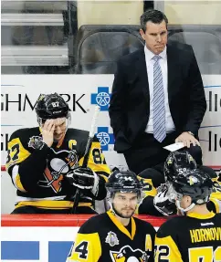  ?? GENE J. PUSKAR / THE ASSOCIATED PRESS ?? It’s hard to say with any certainty whether Sidney Crosby, pictured with coach Mike Sullivan in Game 6, had a “blank and vacant look” following his head injury in Game 3.