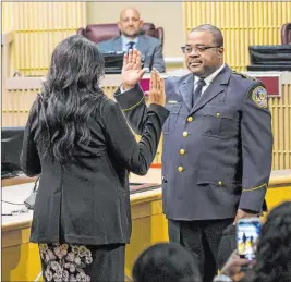  ?? Chase Stevens Las Vegas Review-journal @csstevensp­hoto ?? Henderson Police Chief Thedrick Andres takes the ceremonial oath of office with City Clerk Sabrina Mercadante during a City Council meeting Tuesday.