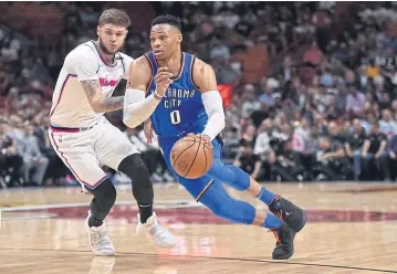  ?? USA TODAY SPORTS ?? Thunder guard Russell Westbrook, right, drives the ball around Heat guard Goran Dragic.