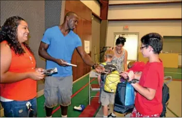  ?? Souderton Independen­t photo
DEBBY HIGH ?? Profession­al boxer Steve “USS” Cunningham stands with his wife, Livvy, as he gives signatures to the kids attending the camp.