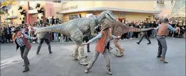  ?? Jesse Grant Getty Images for Universal Studios Hollywood ?? RAPTORS and rangers perform at Universal Studios Hollywood in 2018 at 25th anniversar­y of “Jurassic” film.