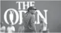  ?? THOMAS J. RUSSO/USA TODAY SPORTS ?? Tiger Woods looks back on the 18th green after finishing his final round at the British Open on Sunday.