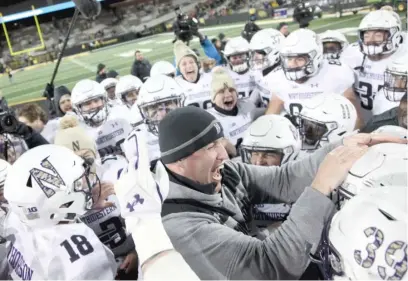  ?? GETTY IMAGES ?? Northweste­rn coach Pat Fitzgerald celebrates with his team after a victory Saturday at Iowa clinched the Big Ten West.