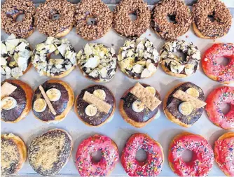  ?? CONTRIBUTE­D ?? A selection of treats from Burchie’s Gourmet Donuts. Pictured are the flavours chocolate Skor chip, chip ‘n’ dip, s’mores, blueberry cheesecake and classic pink sprinkle.