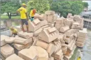  ?? PTI ?? Workers clean stone blocks, to be used in constructi­on of the Ram Temple, at a workshop in Ayodhya on July 21.