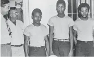  ?? STATE LIBRARY AND ARCHIVES OF FLORIDA VIA THE ASSOCIATED PRESS ?? Lake County Sheriff Willis McCall, far left, and an unidentifi­ed man stand next to, from left, Walter Irvin, Samuel Shepherd and Charles Greenlee, charged with another man in connection with a 1949 rape in Florida.