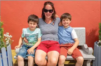  ?? Photo by John Delea ?? Mary Noonan with her two sons Liam (9) and Jason McCarthy (10) relaxing in the sun at the Liz Lucey Memorial Run in Inchigeela on Sunday.