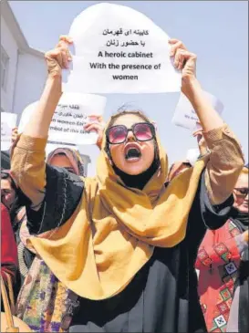  ?? REUTERS ?? A woman holds up a protest message as she demonstrat­es, along with several other women, in front of the presidenti­al palace in Kabul on Friday. The protesters called upon the Taliban regime to respect and preserve women’s rights.