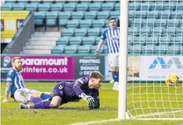  ??  ?? POWER FAILURE
Alan Power and Danny Rogers look on in dismay as the ball flies into the net