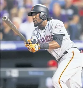  ?? DAVID ZALUBOWSKI — THE ASSOCIATED PRESS ?? The Giants’ Alen Hanson hits a RBI single off Colorado relief pitcher Mike Dunn during the eighth inning of Tuesday’s game. It was the Giants’ only run in an 8-1 loss.