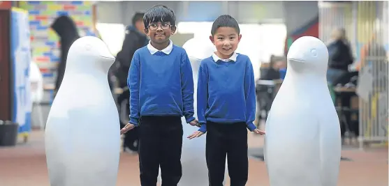  ?? Picture: Kim Cessford. ?? On parade: Moaz Sheak and Jeromy Wei of Our Lady’s RC Primary School, Dundee, alongside two of the penguins.