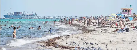  ?? — AFP photo ?? People enjoy a day out in the sun in Miami beach, Florida.