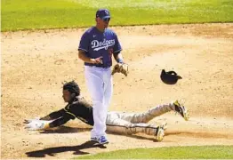  ?? ROSS D. FRANKLIN AP ?? The Padres’ C.J. Abrams steals second base without a throw as Dodgers second baseman Sheldon Neuse pauses in front of the base during the third inning.