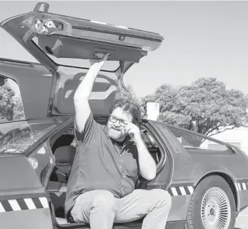  ?? BEN SKLAR/THE NEW YORK TIMES ?? Ernest Cline, an enthusiast of 1980s geek culture and author of “Ready Player Two,” with his DeLorean in Austin, Texas, in 2016.