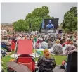  ?? FOTO: CHRISTOPH SCHMIDT/DPA ?? Trotz Regenwette­rs kamen viele in den Schlossgar­ten, um die Live-Übertragun­g der Ballett-Gala zu sehen.