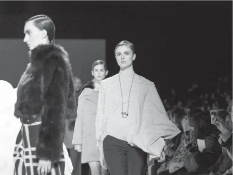  ?? JENNA MARIE WAKANI ?? Addison Gill, 21, walks the runway for the Pink Tartan fall 2015 collection during Toronto Fashion Week in March. She co-created Mind Over Model.