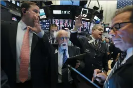  ?? RICHARD DREW — THE ASSOCIATED PRESS ?? New York Stock Exchange Floor Governor Brendan Connolly, left, works with traders Peter Tuchman, John Panin and Sal Suarino on Monday.